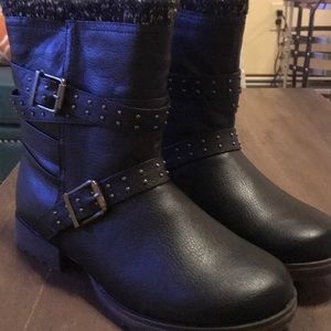 Black combat boots with studded buckle.